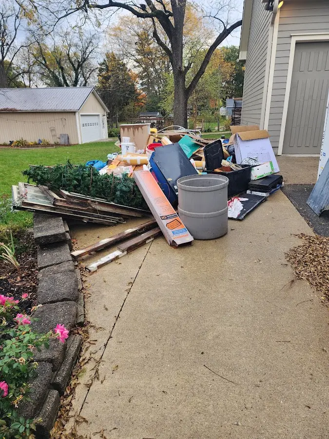 Dumpster being loaded with debris for 12 Yard Dumpster Rental in Wayland